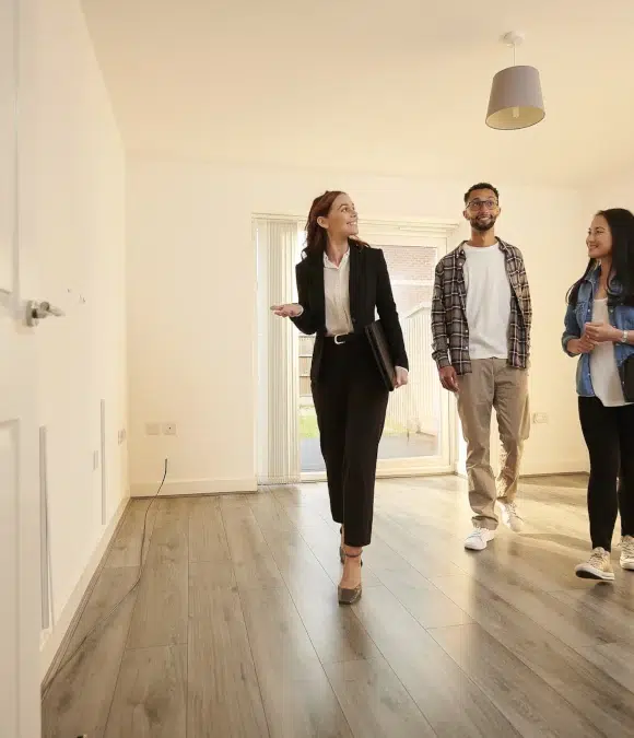 realtor walking couple through a home